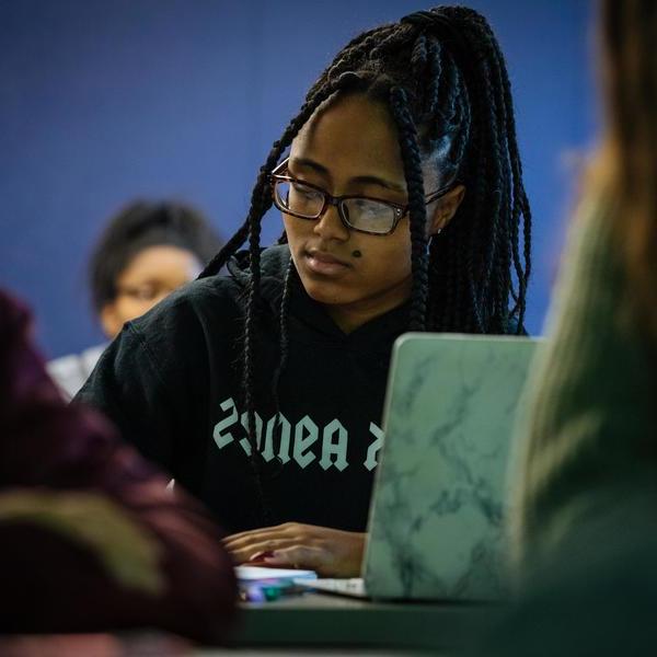 A classical civilizations major student takes notes in class.